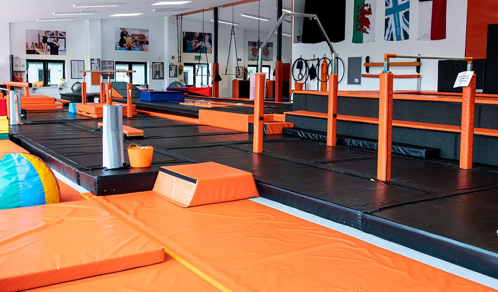 Orange and black matting around gymnastics apparatus