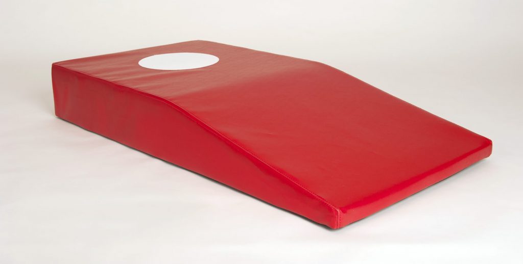 Red foam springboard with a white circular marker